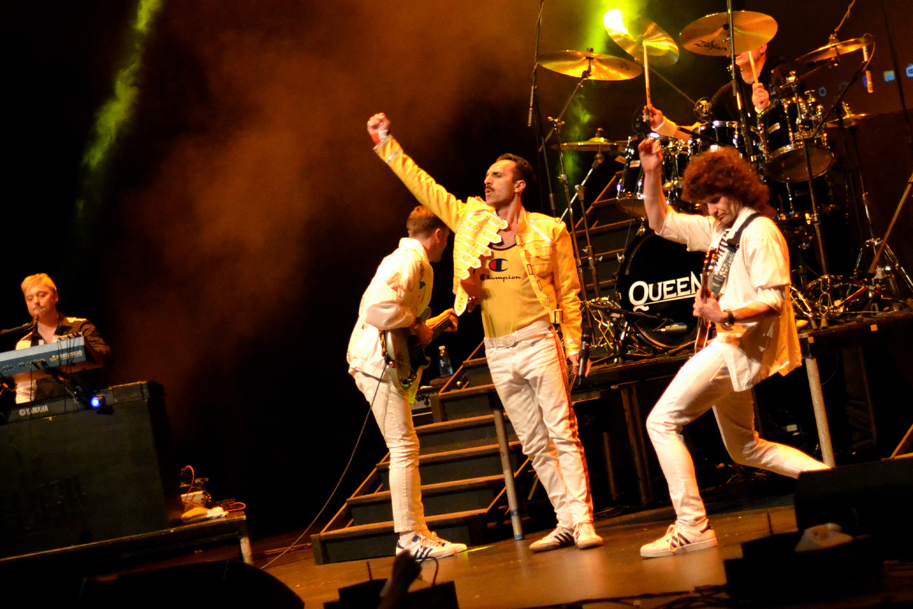 Wide shot of the Flash band performing under crimson stage lighting